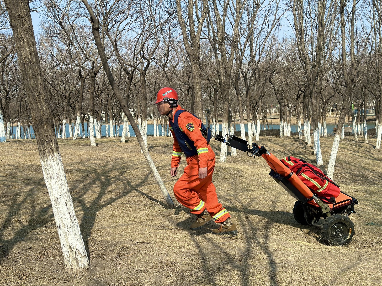 Moving a rescue pack across leaf litter and dry ground.